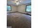 Well-lit bedroom with two windows and carpet flooring at 1500 Pine Forest Rd, Mansfield, GA 30055