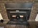Traditional brick fireplace with wood burning stove at 1500 Pine Forest Rd, Mansfield, GA 30055