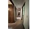 Long hallway with carpet flooring and access to bedrooms at 1500 Pine Forest Rd, Mansfield, GA 30055