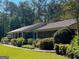 Ranch home with metal roof and mature landscaping at 1500 Pine Forest Rd, Mansfield, GA 30055