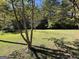 Large backyard with tall trees and grassy area at 1500 Pine Forest Rd, Mansfield, GA 30055