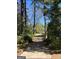 Long driveway leading to a home nestled amongst tall trees at 1500 Pine Forest Rd, Mansfield, GA 30055