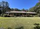 Brick ranch home with a long front porch at 1500 Pine Forest Rd, Mansfield, GA 30055