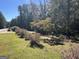 Landscaped backyard with green grass and trees at 1500 Pine Forest Rd, Mansfield, GA 30055