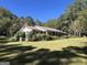 Ranch style home with a carport and well manicured lawn at 1500 Pine Forest Rd, Mansfield, GA 30055
