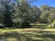 Large backyard with green grass and mature trees at 1500 Pine Forest Rd, Mansfield, GA 30055