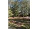 Open, grassy yard surrounded by woods at 1500 Pine Forest Rd, Mansfield, GA 30055