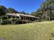 Ranch style home with brick exterior and spacious lawn at 1500 Pine Forest Rd, Mansfield, GA 30055