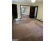 Large bedroom with mirrored closet doors and carpeting at 1500 Pine Forest Rd, Mansfield, GA 30055