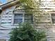 Close up of the house exterior, showing some damage to the siding at 5605 Bethlehem Rd, Fairburn, GA 30213