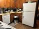 White appliances and wood cabinets in this kitchen at 5605 Bethlehem Rd, Fairburn, GA 30213