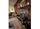 Cozy living room featuring a brick fireplace, wood burning stove and ceiling fan at 5605 Bethlehem Rd, Fairburn, GA 30213