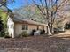 Side view of the house, highlighting the landscaping and covered patio at 5605 Bethlehem Rd, Fairburn, GA 30213