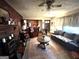 Living room with brick fireplace, ceiling fan, and comfortable seating area at 5605 Bethlehem Rd, Fairburn, GA 30213