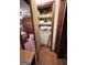 Open linen closet with shelves and stacked items at 5605 Bethlehem Rd, Fairburn, GA 30213