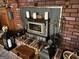 Brick fireplace with wood stove and decorative accessories at 5605 Bethlehem Rd, Fairburn, GA 30213