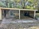View of a carport with lattice sides and storage area at 5605 Bethlehem Rd, Fairburn, GA 30213
