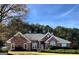 Brick house with a large front yard and mature trees at 3845 Glen Ian Dr, Loganville, GA 30052