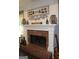 Brick fireplace with white mantel and Gathering photos at 3845 Glen Ian Dr, Loganville, GA 30052