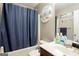 Bathroom with tub, shower, vanity, and dark blue shower curtain at 326 Cog Hill Dr, Fairburn, GA 30213