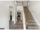 Bright entryway with hardwood floors, staircase, and views into living room at 326 Cog Hill Dr, Fairburn, GA 30213