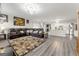 Open living room with large sectional sofa, fireplace, and kitchen view at 326 Cog Hill Dr, Fairburn, GA 30213