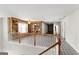 Open loft area with built-in shelving and hardwood floors at 326 Cog Hill Dr, Fairburn, GA 30213