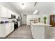 Modern kitchen with white cabinets, island, and stainless steel appliances at 326 Cog Hill Dr, Fairburn, GA 30213