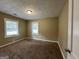 Bright bedroom with neutral walls, carpeting and two windows at 1764 Thomas Ter, Decatur, GA 30032