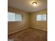 Bright bedroom with neutral walls and carpet flooring and two windows at 1919 Glenmar Dr, Decatur, GA 30032