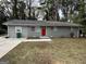 Ranch home with gray siding, red door, and green lawn at 1919 Glenmar Dr, Decatur, GA 30032