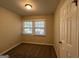 Well lit bedroom with neutral colored walls and carpet at 4433 Mercer Rd, Decatur, GA 30035