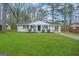 Ranch style home with a spacious lawn and covered porch at 4433 Mercer Rd, Decatur, GA 30035