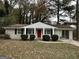 Brick ranch home with red door and carport at 4433 Mercer Rd, Decatur, GA 30035
