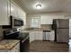 Modern kitchen with white cabinets, granite countertops and stainless steel appliances at 4433 Mercer Rd, Decatur, GA 30035