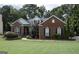 Brick house with landscaped lawn and large windows at 9168 N Links Dr, Covington, GA 30014