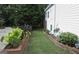 Landscaped side yard with brick border at 9168 N Links Dr, Covington, GA 30014