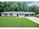 Newly renovated ranch home with carport and spacious lawn at 2997 Tara Woods Dr, Douglasville, GA 30135