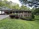 Brick house with covered porch and sloping lawn at 9267 Westview Sw Dr, Covington, GA 30014