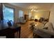 Living room with hardwood floors, comfy seating, and a piano at 9267 Westview Sw Dr, Covington, GA 30014