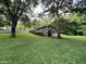 Brick house on a grassy lot with large trees and a swing set at 9267 Westview Sw Dr, Covington, GA 30014