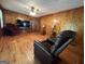 Living room with wood walls, hardwood floors, and comfortable seating at 9267 Westview Sw Dr, Covington, GA 30014