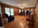 Living room with wood walls, hardwood floors, and a large TV at 9267 Westview Sw Dr, Covington, GA 30014