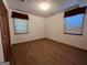 Simple bedroom with hardwood floors and two windows at 9267 Westview Sw Dr, Covington, GA 30014