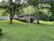 Brick house on a grassy lot with large trees and a swing set at 9267 Westview Sw Dr, Covington, GA 30014