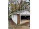 Detached single car garage with open door, brick and painted exterior at 554 Forest Hill Dr, Stockbridge, GA 30281