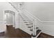 Grand staircase with white railings and dark hardwood floors at 1898 Walker Ave, College Park, GA 30337