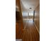 Long basement hallway with light brown laminate flooring at 5003 Pineview Ter, Fayetteville, GA 30214