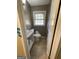 Clean bathroom with single sink vanity, toilet and tile floor at 5003 Pineview Ter, Fayetteville, GA 30214