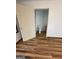 Small bathroom with toilet and shower, featuring wood-look flooring at 5003 Pineview Ter, Fayetteville, GA 30214